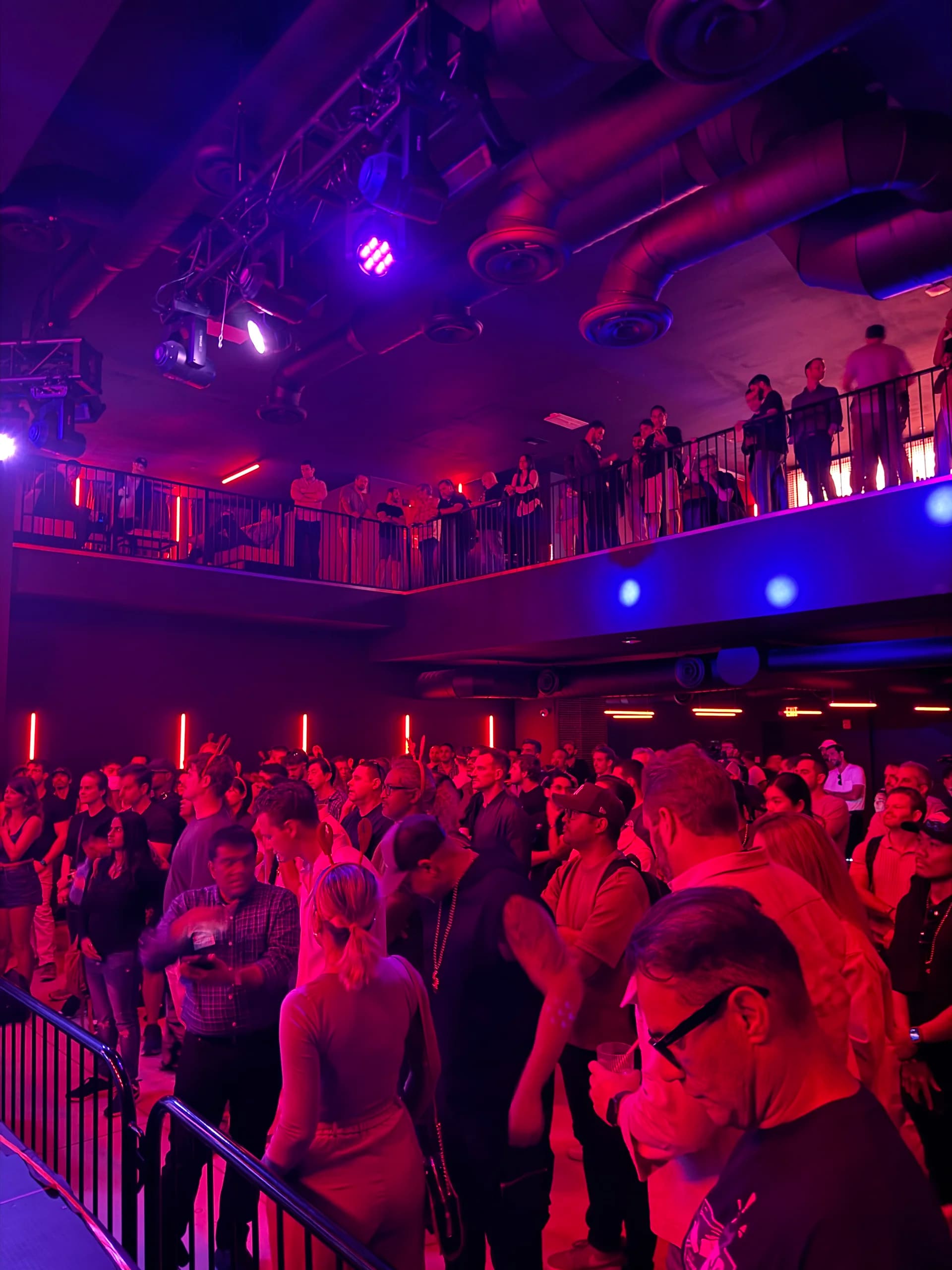 Packed crowd at ClawCon watching from two levels