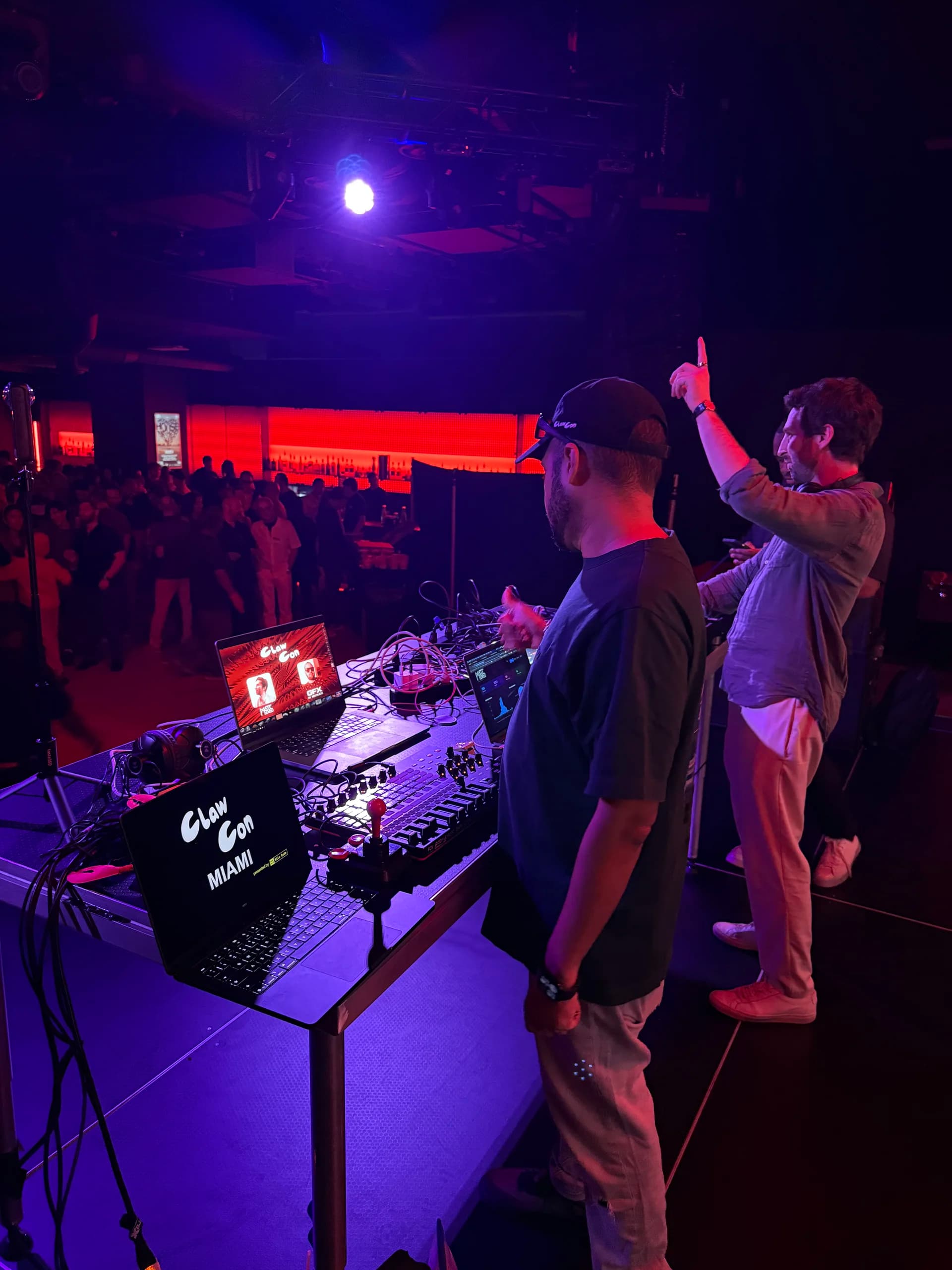 Performing live with crowd and ClawCon branding