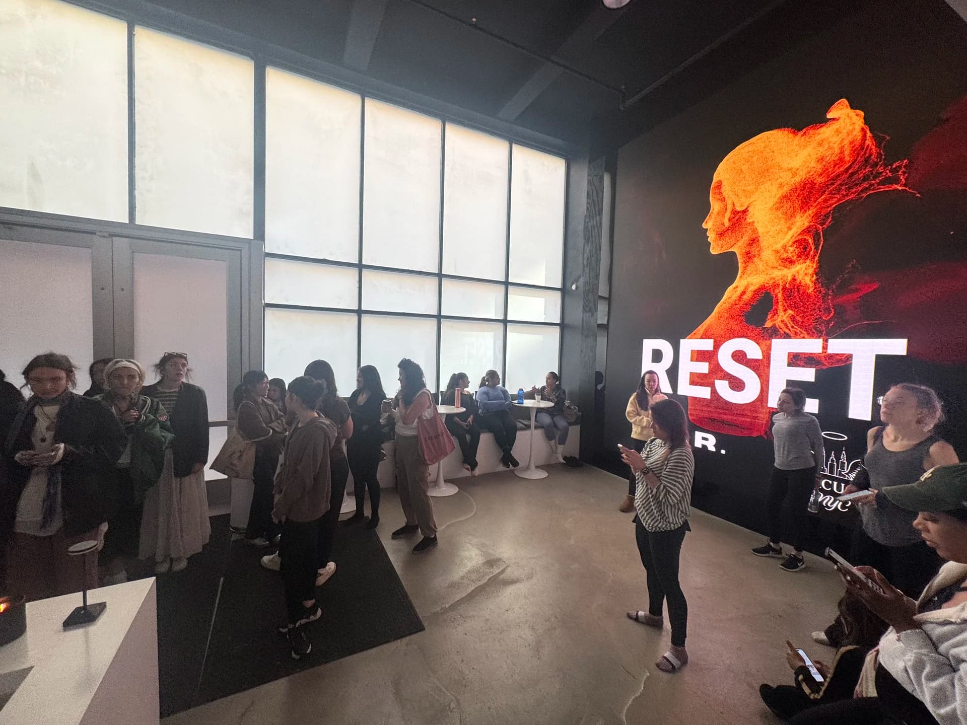 Attendees arriving with RESET poster on LED wall