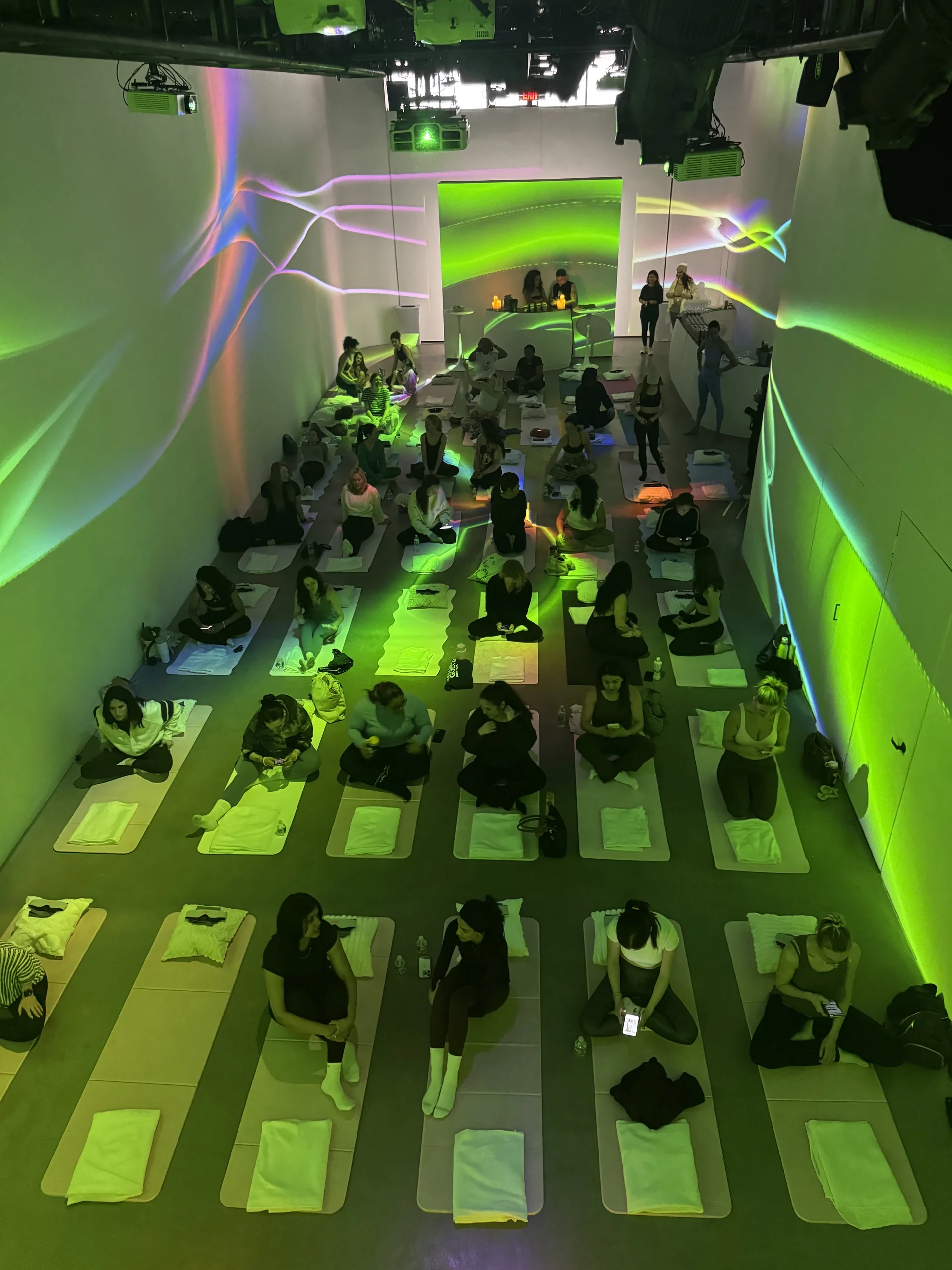Overhead view of full room bathed in green generative projections