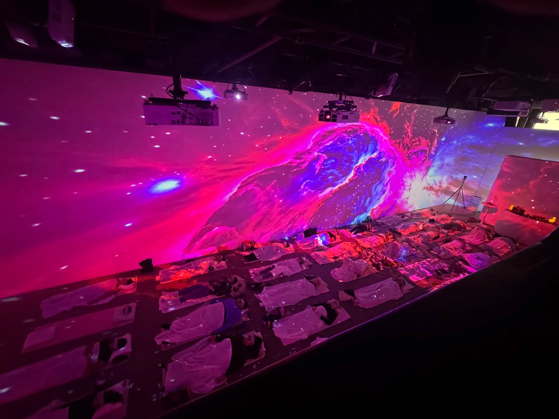 Pink and blue nebula projections across the LED wall