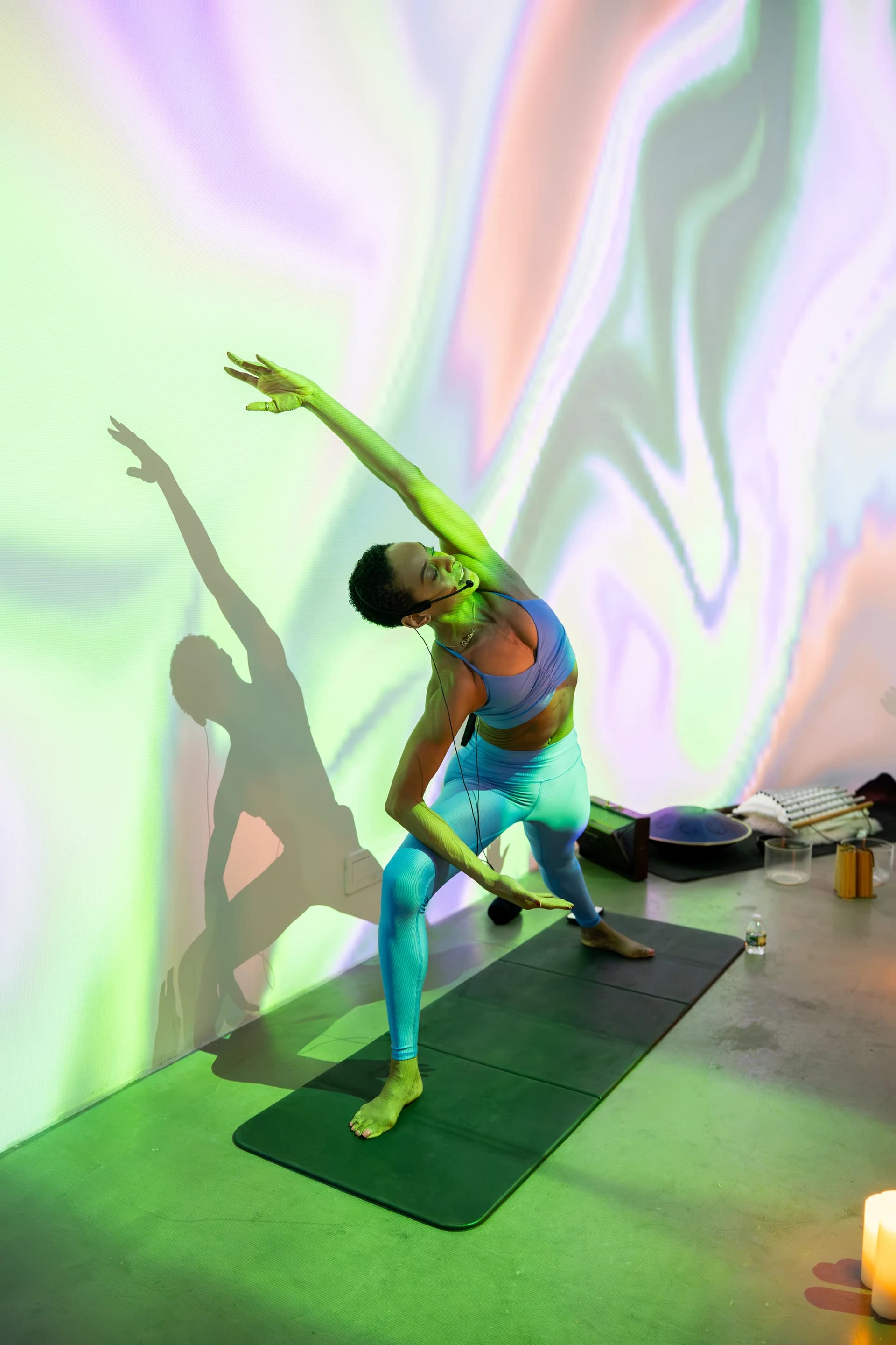 Yoga pose with generative marble projections casting shadows
