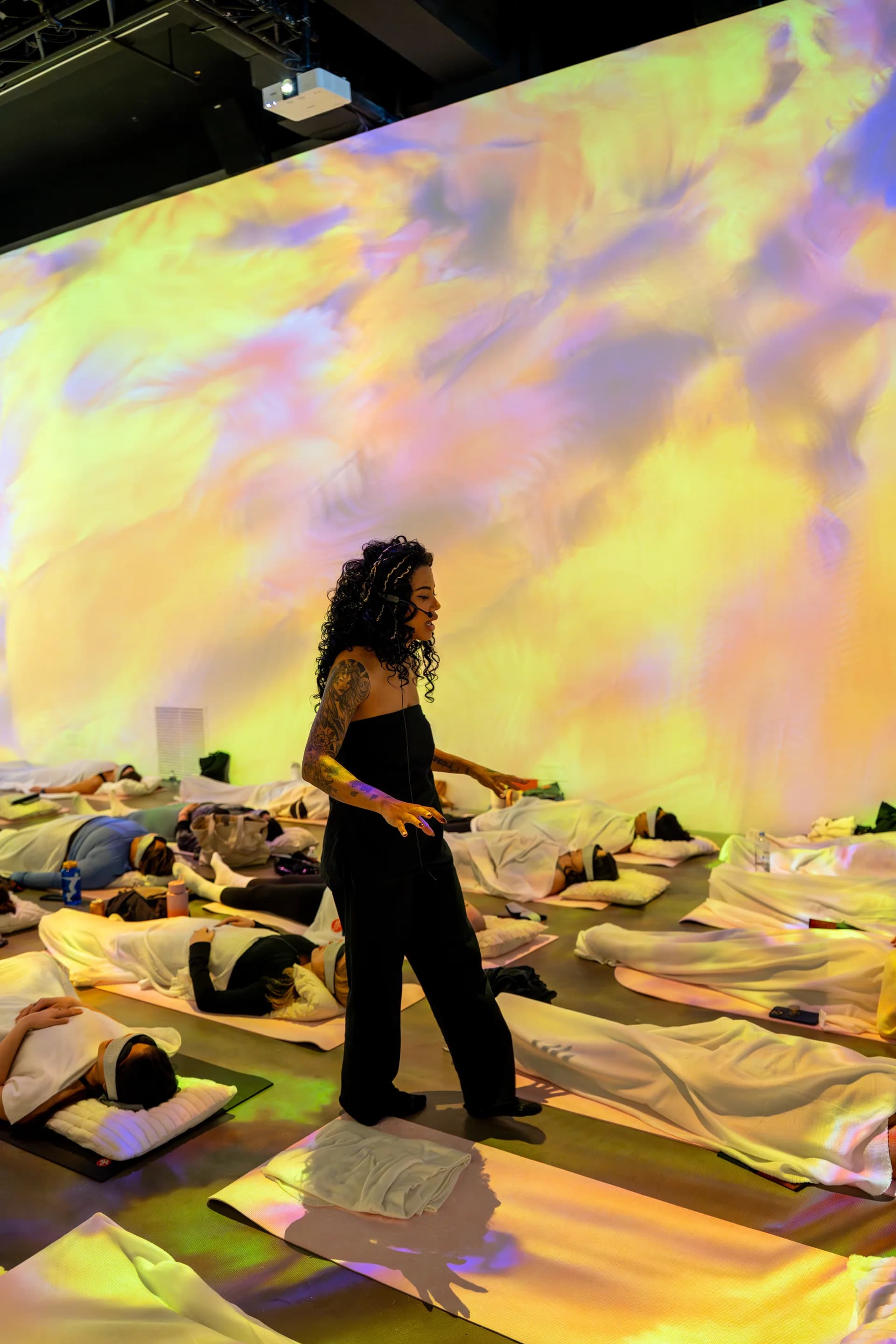 Instructor bathed in warm golden generative projections